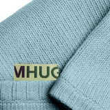 Dettaglio con logo Mhug di copertina in misto cachemire di colore celeste